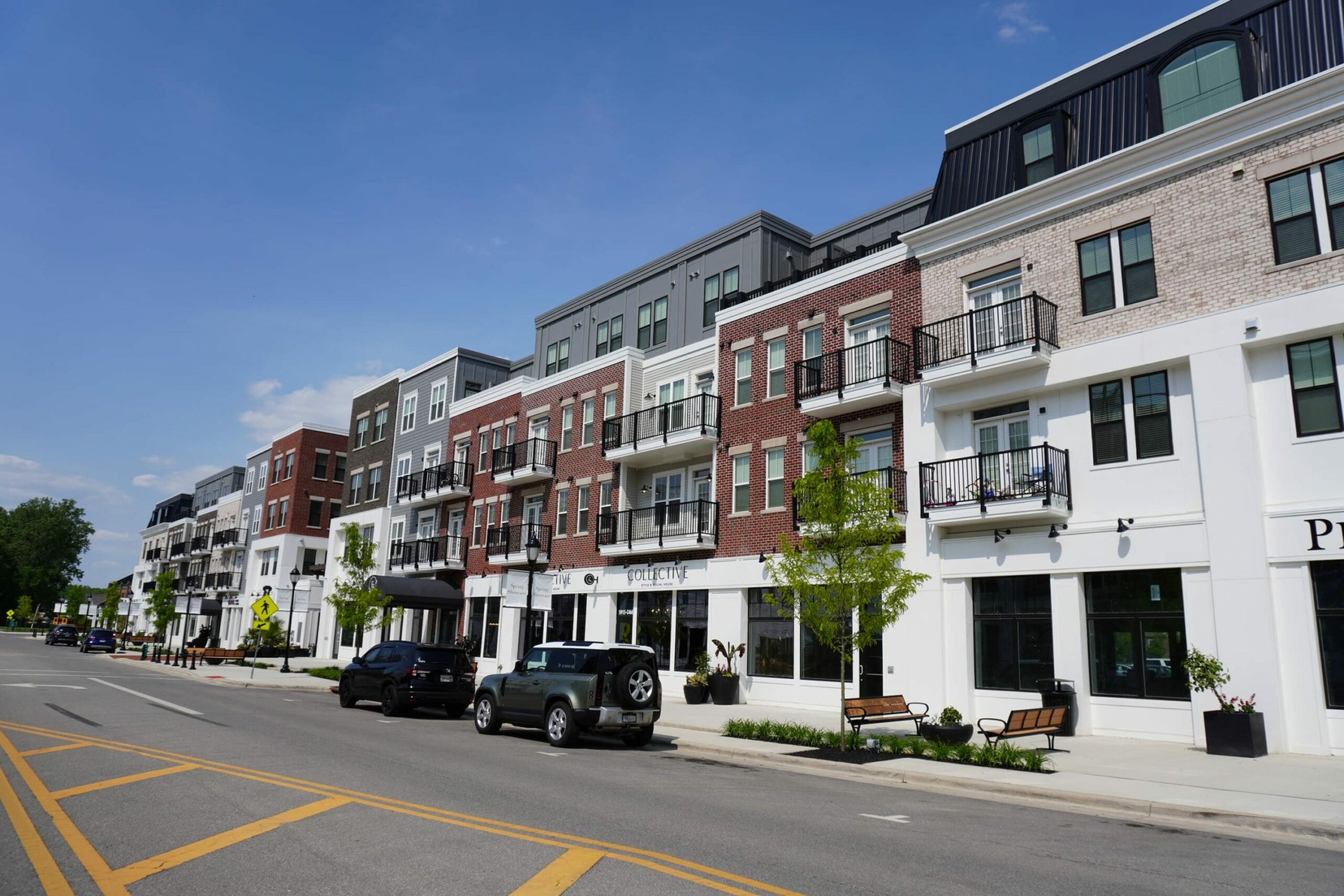 A row of apartment buildings on a street.