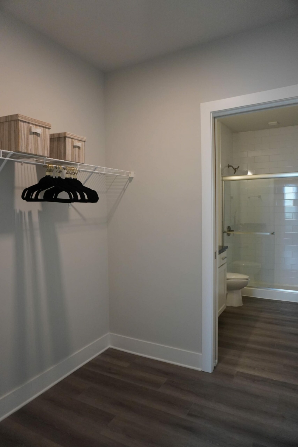 A room with a closet and a shower.