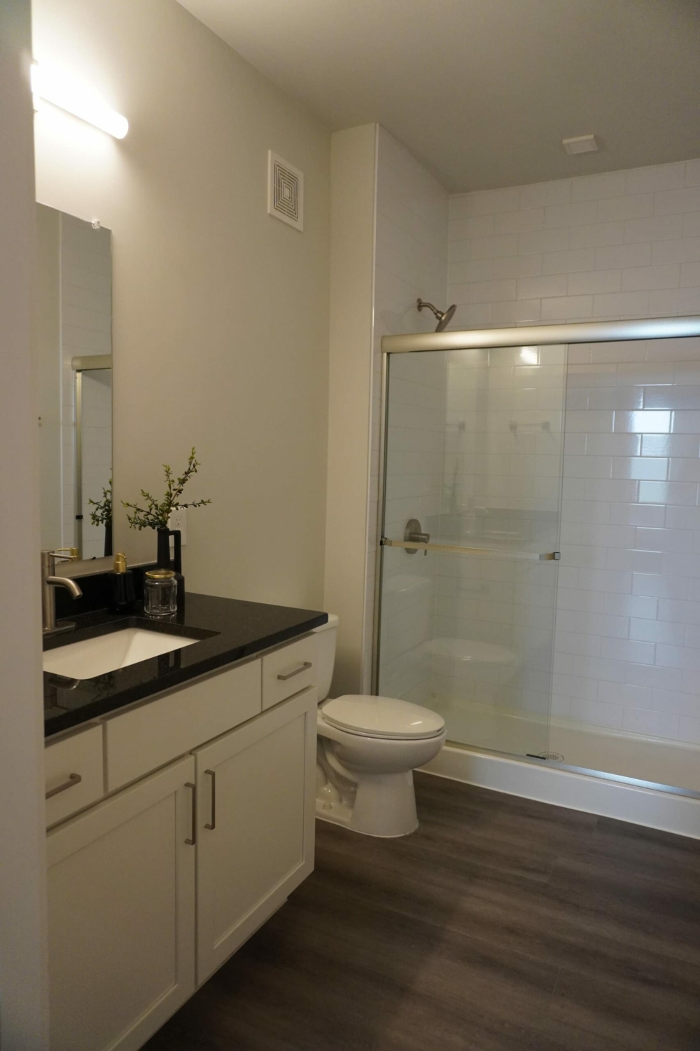 A white bathroom with a glass shower stall.