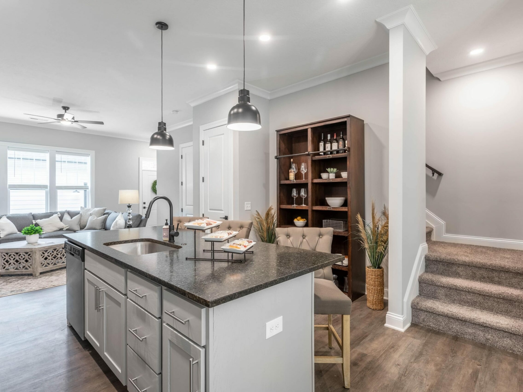 A kitchen in a home with hardwood floors and stainless steel appliances.