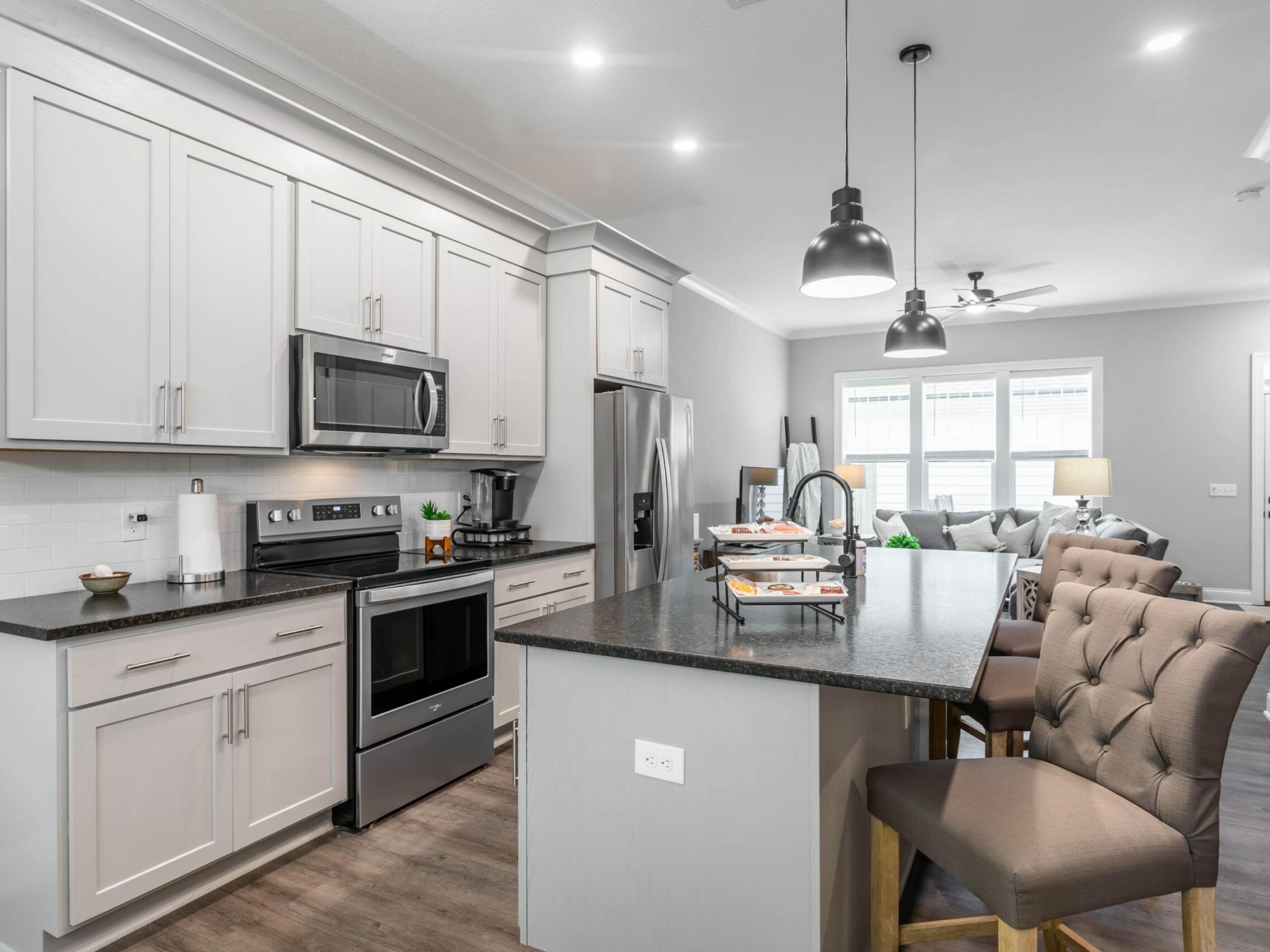 A kitchen with white cabinets and stainless steel appliances.