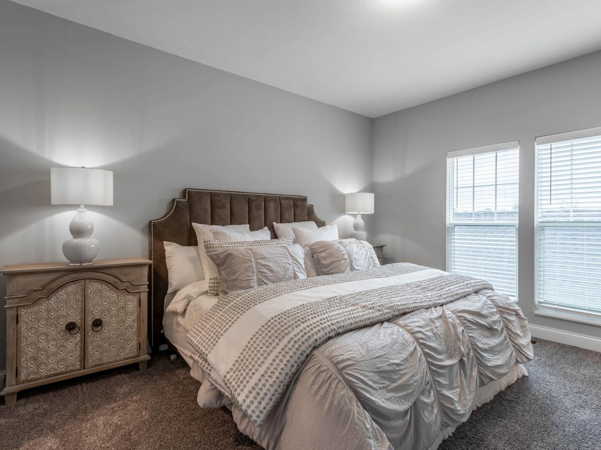 A bedroom with gray walls and a bed.
