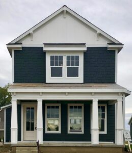 A blue and white house with white trim.
