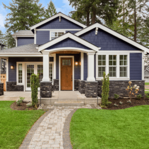 A home with blue siding and a pathway to the front door.