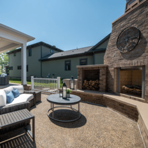 An outdoor living area with a fireplace and patio furniture.