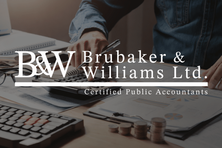 Desk with financial documents, a calculator, coins, and a keyboard. A person in a blue shirt works in the background. Text: "Brubaker & Williams Ltd. Certified Public Accountants – Proudly serving the Evans Farm neighborhood.