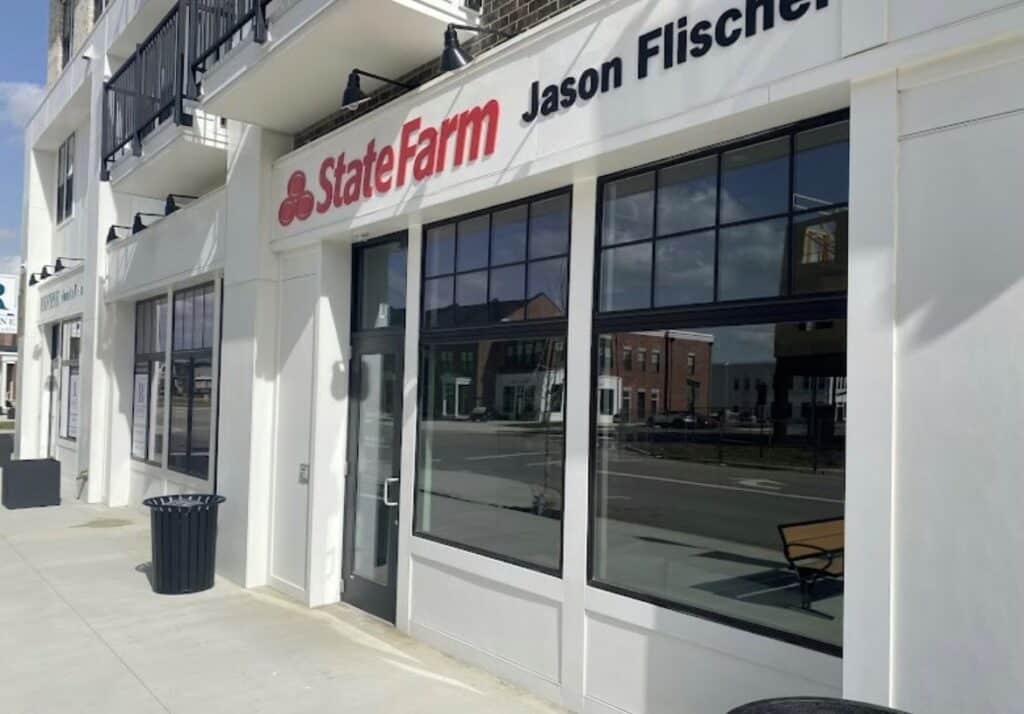 Street view of a storefront with a "State Farm" sign and "Jason Fischer" displayed above the entrance. Located in the heart of the Evans Farm neighborhood, the building features large windows and a modern design along a clean sidewalk.